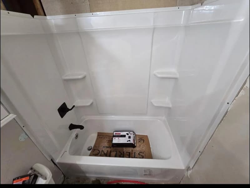 New white tub and shower surround installed